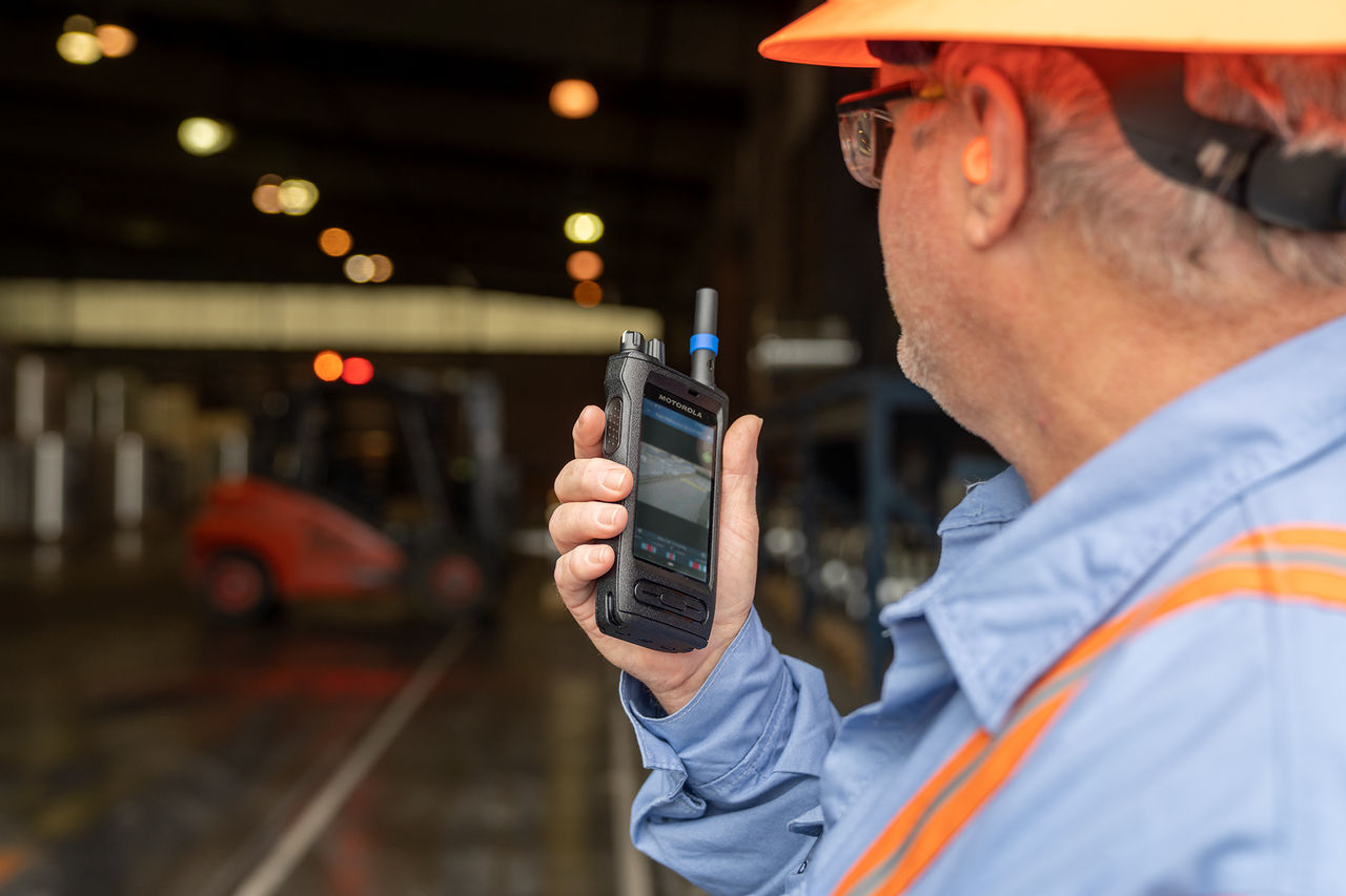 Man with a Motorola radio at a construction site